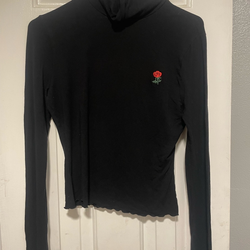 Black turtleneck with a rose
